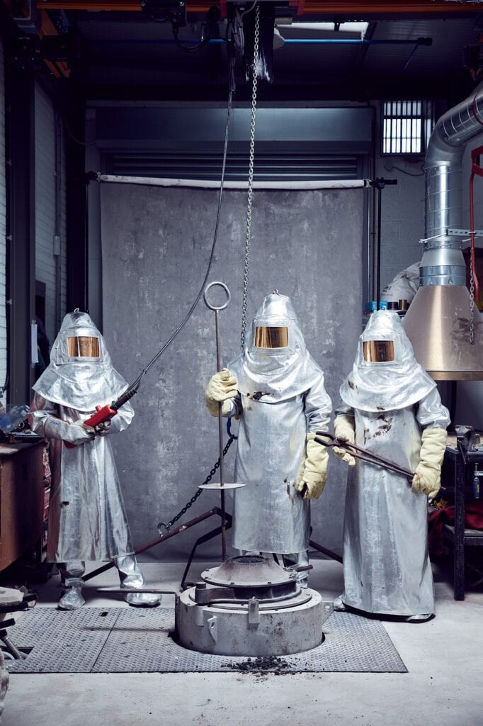 3 figures in protective suits