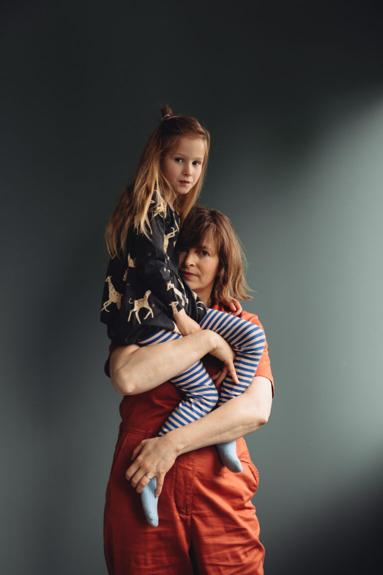 Ola and Zoe: 
Photographer Ola O. Smit holding her daughter Zoe, shot at her photography studio in East London.