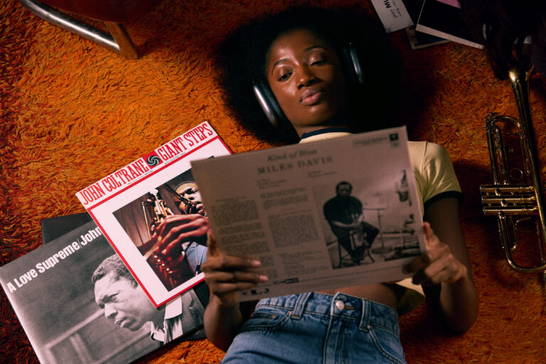 © Owen Harvey, Miles Ahead - Abena listens to records through her headphones, whilst relaxing on the studio floor.