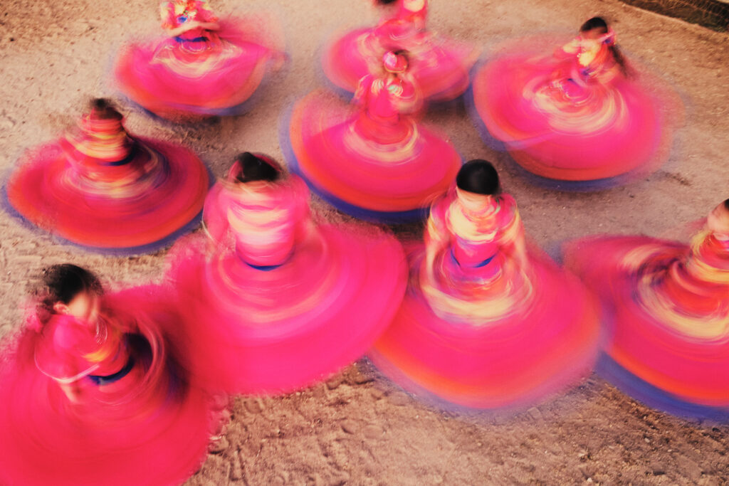 © Owen Harvey - Before training the escaramuza girls take time to have fun, doing dance routines and spinning in their tradition dresses. Jurupa Vallery, California. 2024.